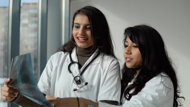 Indian medical students interns analyze the X-ray in a modern clinic. Indian doctor. Higher Education for woman