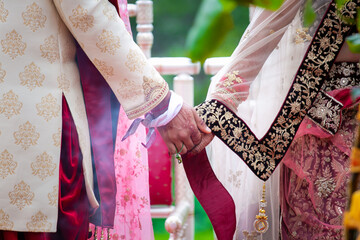 Indian Hindu couple's holding hands close up, wedding ceremony, religious items and rituals, pooja