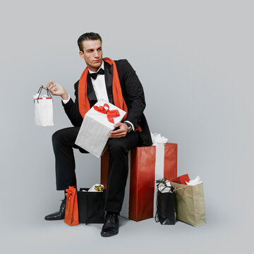 Man in Tuxedo Surrounded with Christmas Gifts and Presents