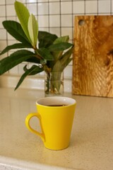 yellow coffee mug on the kitchen table