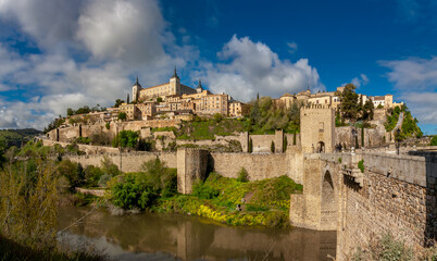 Fototapeta premium City View of Toledo at Alcantara Bridgehead by the Tagus River bank in Toledo, Spain.