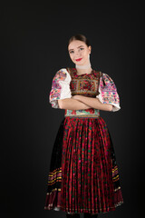 Fototapeta premium Young beautiful slovak woman in traditional dress. Slovak folklore