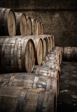 Wooden barrels and casks sit in a pile
