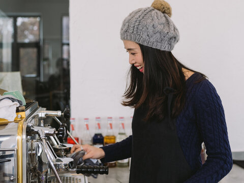 young charming woman making coffee in the kitchen