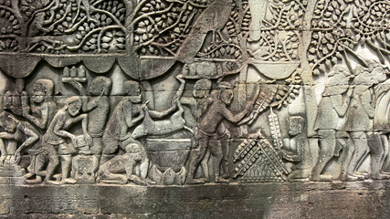 Fototapeta na wymiar Ancient Khmers making food in reliefs in Angkor, Cambodia