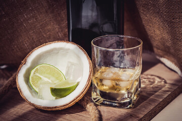 bottle of rum with lime ice and coconut