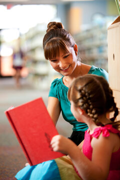 Library: Librarian Helps Little Girl With Book