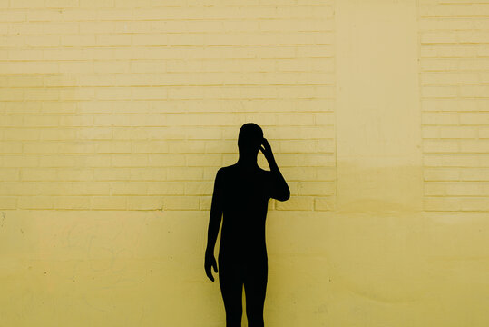 Shadow Costume on Yellow Wall