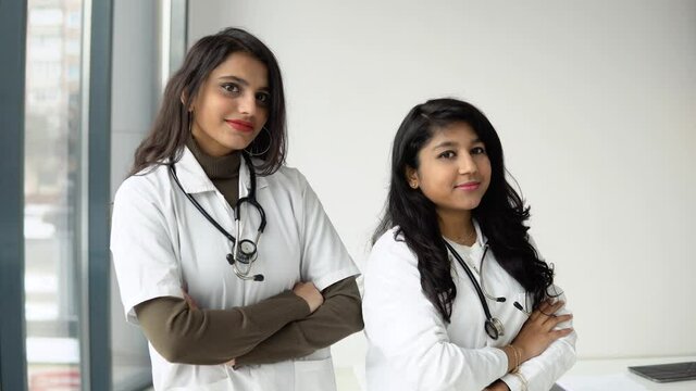 Two young Indian woman doctor looking at camera