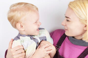 Young aunt having fun with her little nephew on a white background.