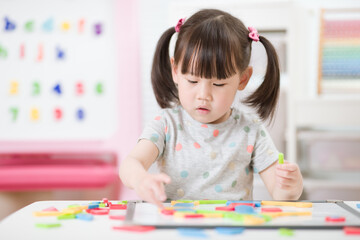 young girl playing creative toy blocks for homeschooling