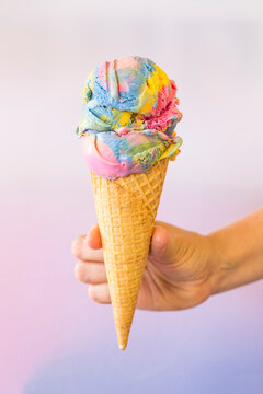 Hand holding an icecream in a cone