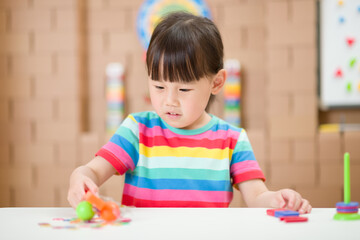 young  girl  play magical magnet experiments at home for homeschooling