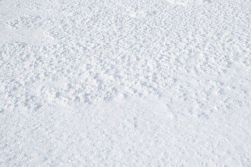 Snow background. White snowy ground. Nature in hibernation during winter.