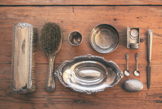 Overhead of antique silver objects.