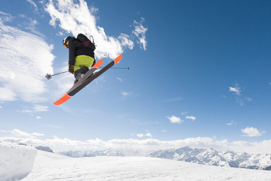 Male freeride skier doing midair tricks in the snowpark