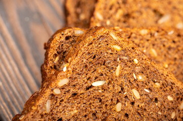 Grain bread sliced on a wooden table.