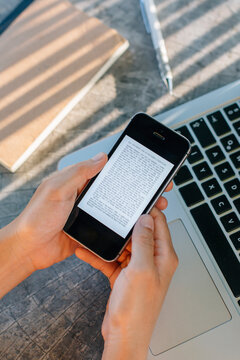 Woman reading text, book on phone