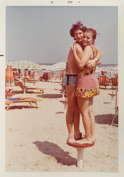 70's couple hug at the beach