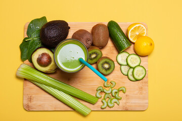 Green smoothie and fruits around