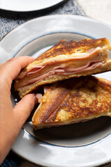 Ham and melted cheese sandwich called Monte Cristo on white background