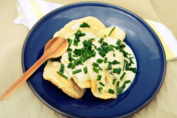 Pierogi with sheep cheese on blue plate.High quality photo.