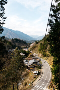 looking out from forest on small japanese village in kiso valley during hike through small towns adventure