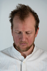 Obraz premium Close up portrait of a man where he is angry looking down and his hair is drilled