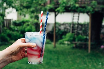 Woman's hand holding a USA themed drink