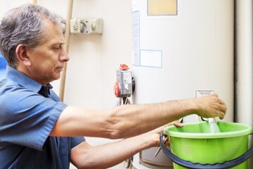 Man checking water boiler at vacational rental property