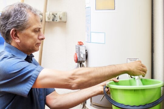 Man checking water boiler at vacational rental property