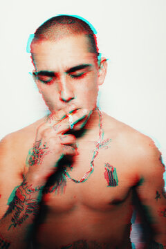 Tattooed young man smokes on RGB
