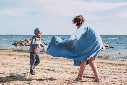 Mother playing with her son at seaside