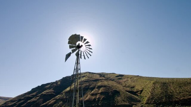 Windmill against sun