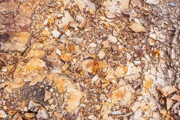 Sedimentary rock. Sedimentary rocks broken on pieces on the ground.