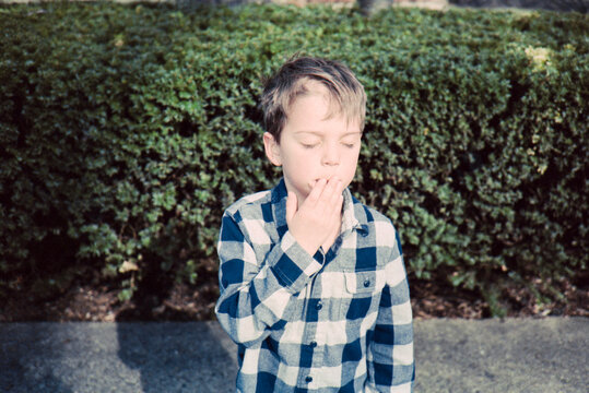 Facepalm gesture from a young boy