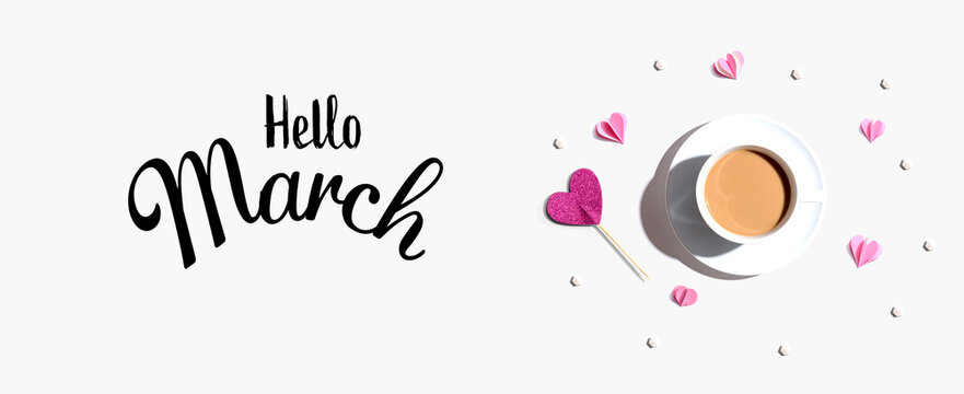 Hello March message with a cup of coffee and paper hearts - flat lay