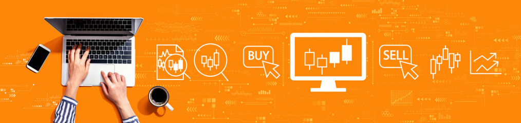 Obraz na płótnie Canvas Stock trading theme with person using a laptop computer