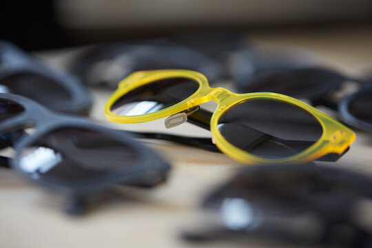 Close up of a set of sunglasses with one of a different color than the rest