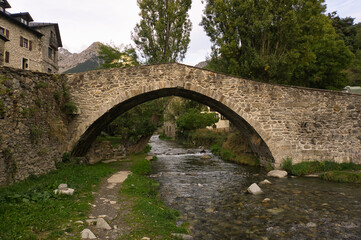 Fototapeta na wymiar Stone bridge in Sallent de Gallego town, located in Hueca, Aragon, Spain.