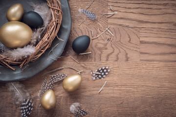 Background with golden decorated easter eggs. Traditional wooden copyspace background