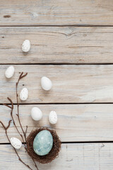 Obraz na płótnie Canvas Easter still life with traditional decorative eggs in nest. Wooden spring easter copyspace background