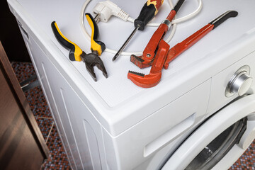 laundry washing machine repair concept. handyman fix washing appliance