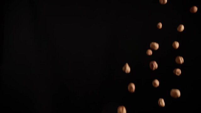 Slow motion of explosion of hazelnut flying in flames
