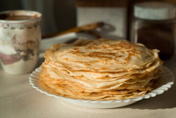homemade pancakes. in the photo, pancakes cooked at home, illuminated by sunlight in the kitchen, close-up