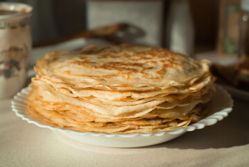 homemade pancakes. in the photo, pancakes cooked at home, illuminated by sunlight in the kitchen, close-up