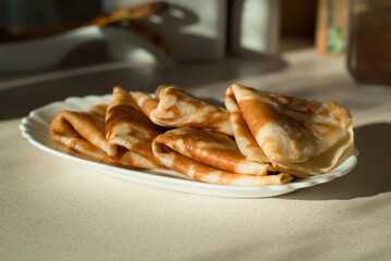 homemade pancakes. in the photo, pancakes cooked at home, illuminated by sunlight in the kitchen, close-up
