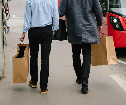 Two male friends shopping in London.