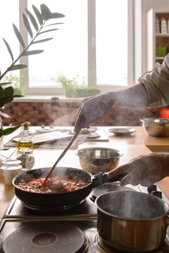 Cook making stew meat in pan