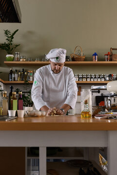 Professional cook kneading dough